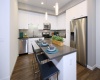 Island Kitchens, hard surface flooring, quartz countertops, subway tile backsplash, stainless steel appliances 