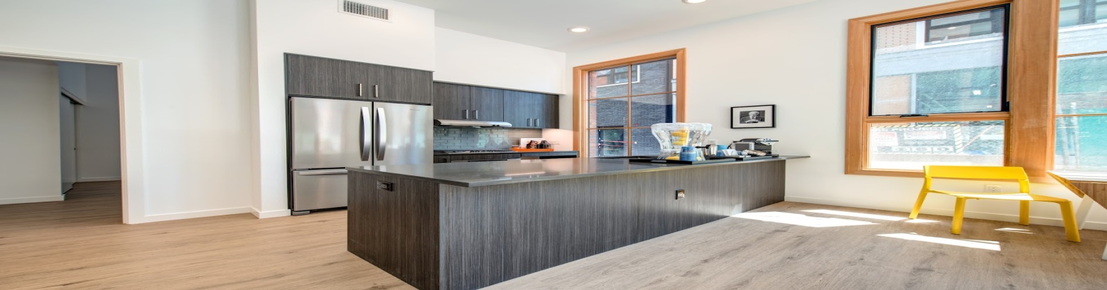 Stainless steel appliances, gas stovetops, wood plank flooring 